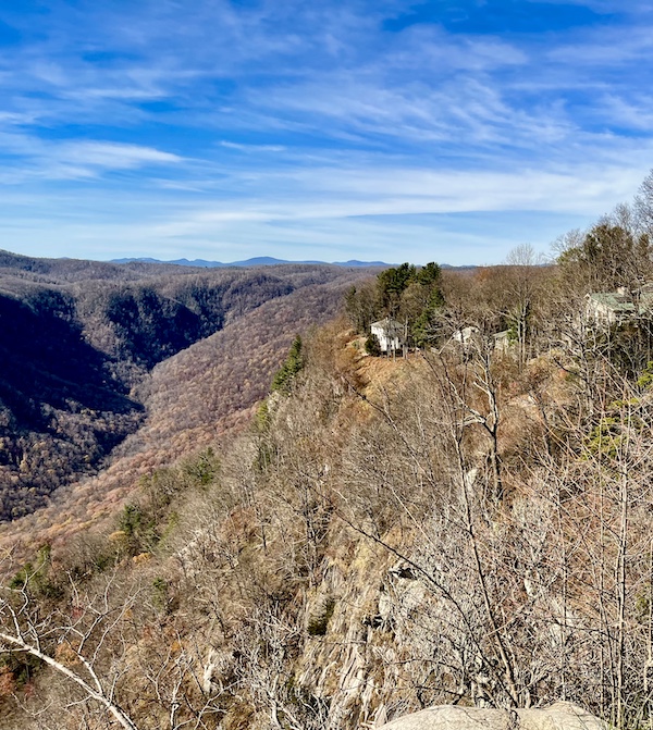 White houses on top of a mountain looking out at a canyon and beyond. Happily Back to Writing!