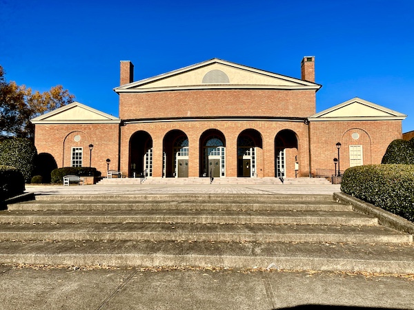 Red brick building atop steps. Building resembles the coliseum. This was seen while on our