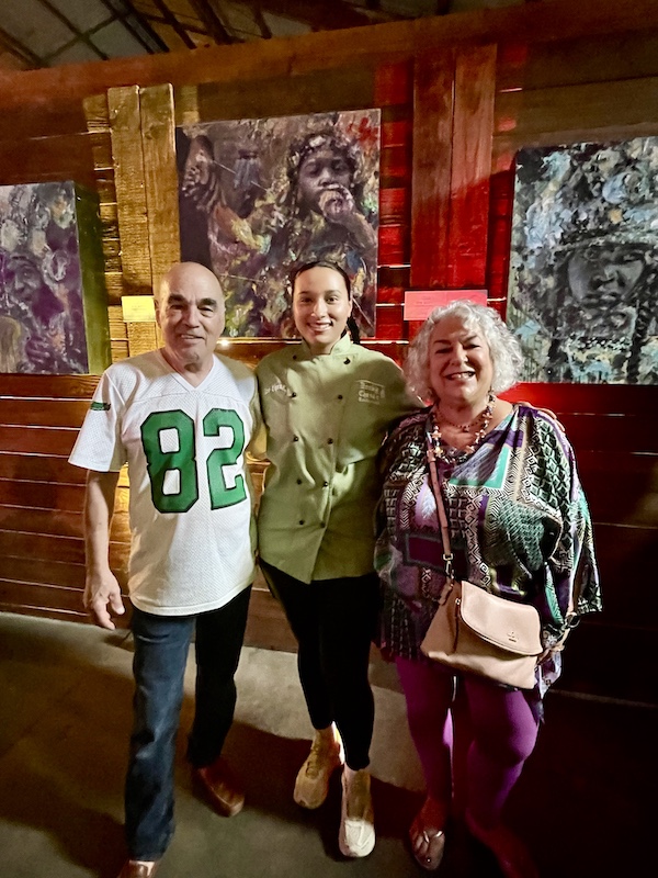 Steve and I with a young woman in a green chef coat at the Family Style FoodFest NOLA