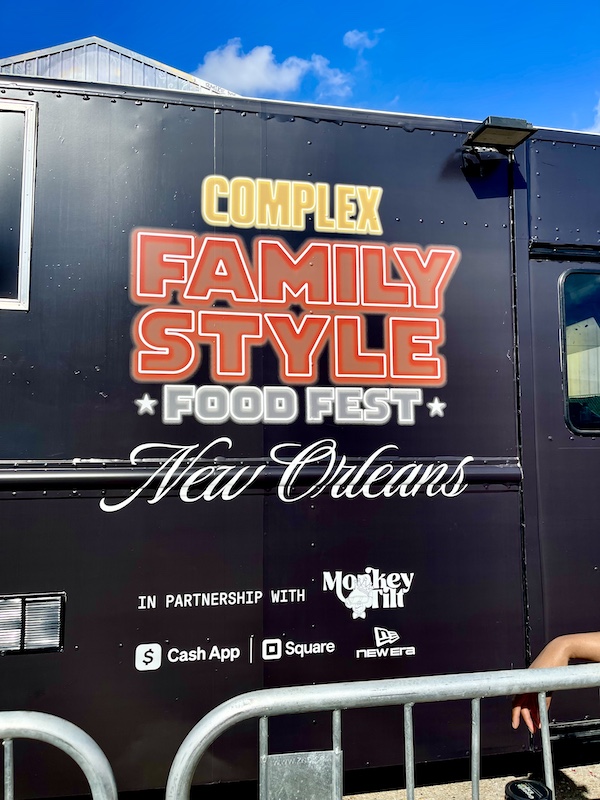 Black truck with red and yellow wording welcomes us to the Family Style FoodFest NOLA