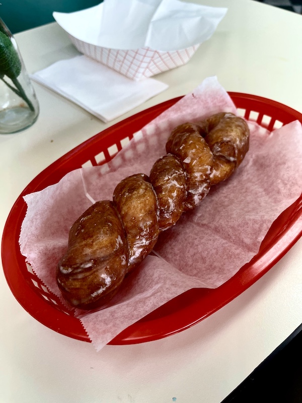 Cinnamon twist don't in a red plastic basket was dessert after enjoying our Delicious Texas Kolaches