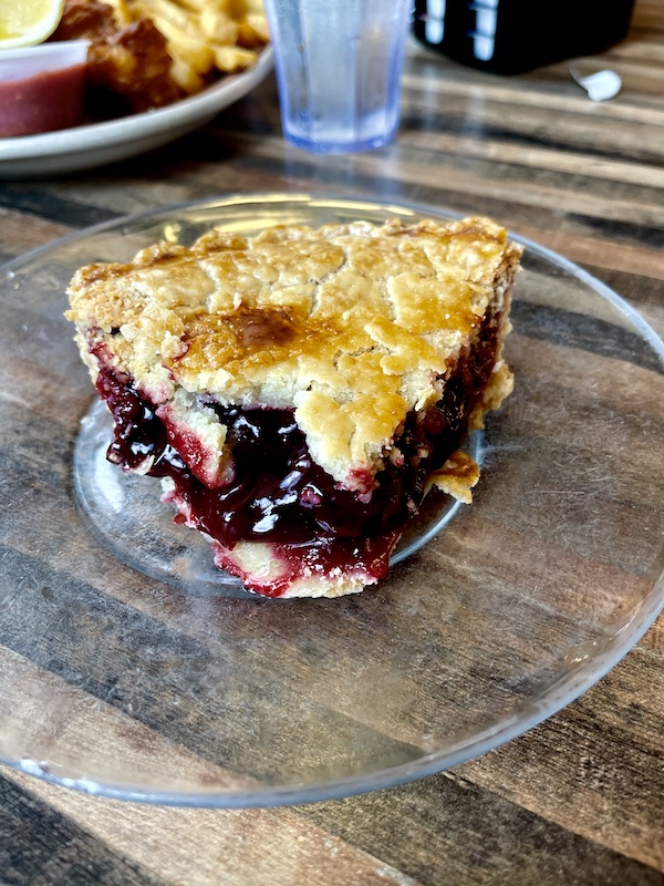 Clear glass plate topped with with a double crust slice of cherry pie at House of Pies Houston Texas