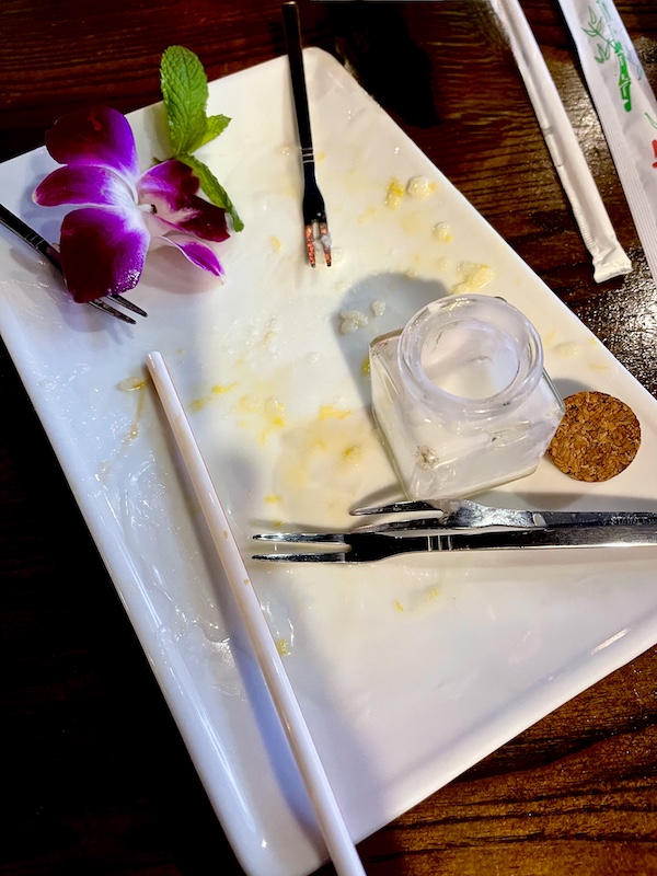 White plate with remnants of dessert at Thaicoon Restaurant Pearland Texas