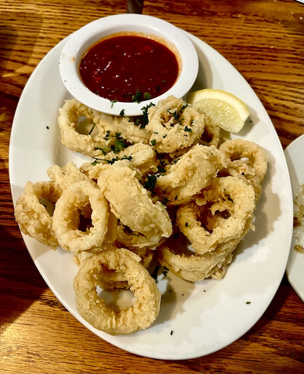Oval platter of lightly battered fried calamari and ramekin of red sauce at Italian Garden Restaurant Canyon Lake TX