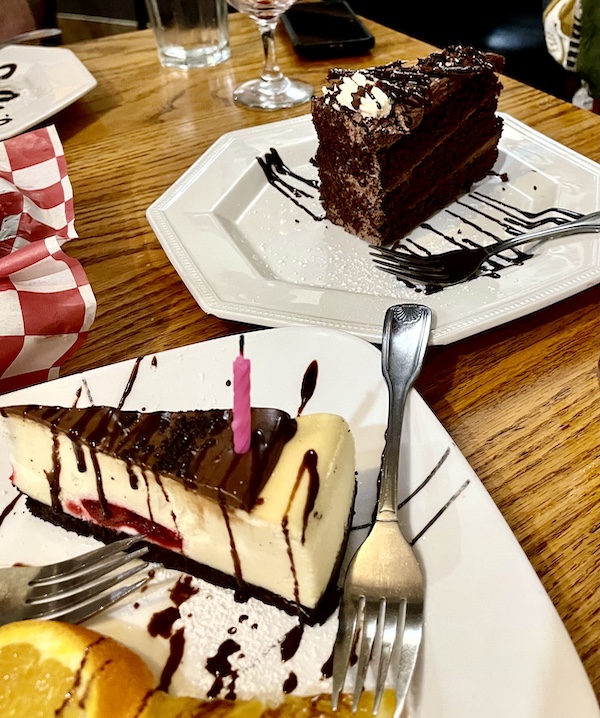 Two dessert plates topped with cheesecake wedge and chocolate mousse cake square at Italian Garden Restaurant Canyon Lake TX