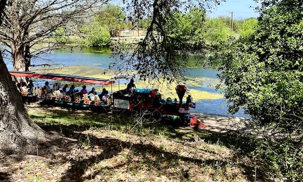 Choo Choo train with people traveling along the river at Landa Park New Braunfels TX