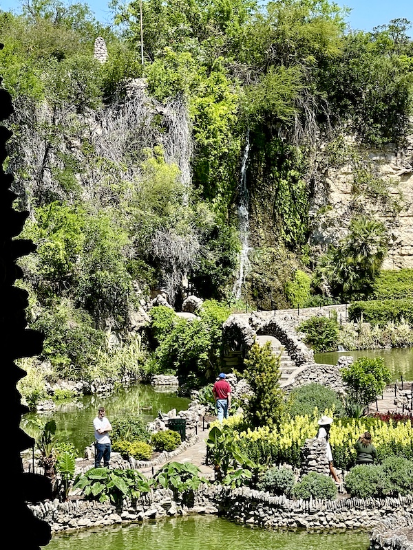 Spanish moss hangs from trees, people strolling through the Japanese Tea Garden San Antonio