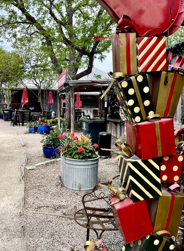 Gift shop with red, black and white wrapped gift boxes stacked in front in New Braunfels and Gruene Texas