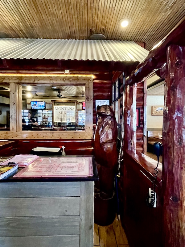 Inside a restaurant with a wood carved bear who appears to be standing guard in New Braunfels and Gruene Texas