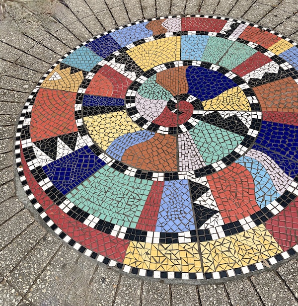 Colorful mosaic sundial embedded in the walkway at San Antonio River Walk