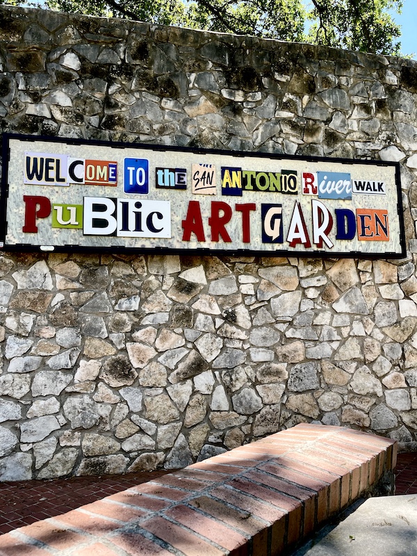 Mosaic on stone wall welcomes you to the San Antonio River Walk