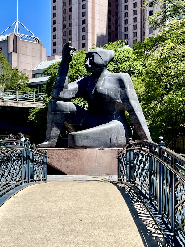 Huge black stone statue of woman with object in her hand at Citlali (Stargazer) by Pedro Reyes in 2022 of volcanic rock and marble