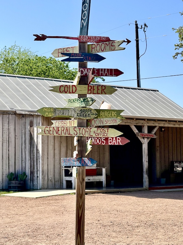 Colorful fun directional sign outside a store on our Sunday Funday Fredericksburg Texas
