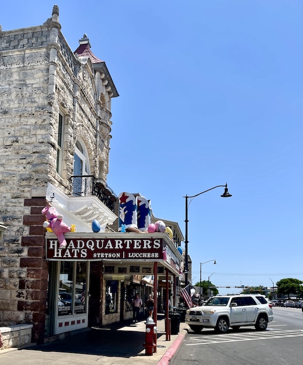 Hat store where we shopped during our Sunday Funday Fredericksburg Texas with huge boots on display about entryway.