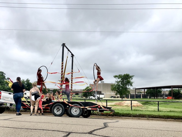 Hopkins County Dairy Festival 2025 parade float with acrobatic performers.
