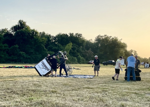 Men uprighting a hot air balloon basket at the Hopkins County Dairy Festival 2025