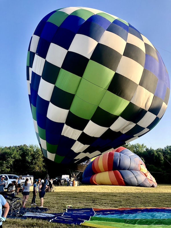 Checkered hot air balloon being filled with air at the Hopkins County Dairy Festival 2025