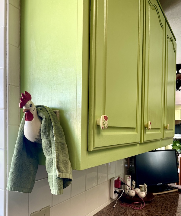 Kitchen Transformation in Texas view of upper cabinet with white and red chicken towel holder