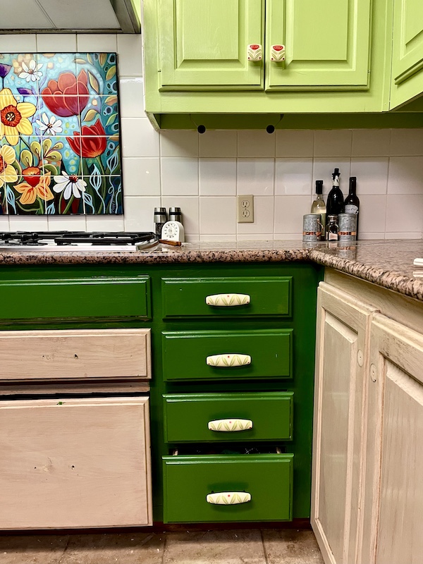 During Kitchen Transformation in Texas part of the cabinets are painted in greens and part are still beige.