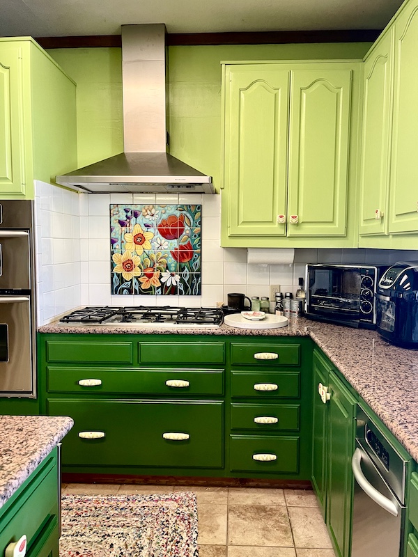 Kitchen Transformation in Texas view of stove, mosaic, hood and cabinets