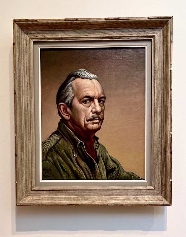 Portrait of a man with silver hair in an olive green button-down shirt and dark red ascot at the Westmoreland Museum of American Art
