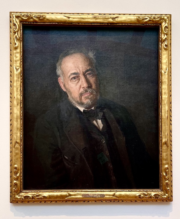 Portrait of a man in a 3 piece black suit, white shirt and black bowtie at the Westmoreland Museum of American Art