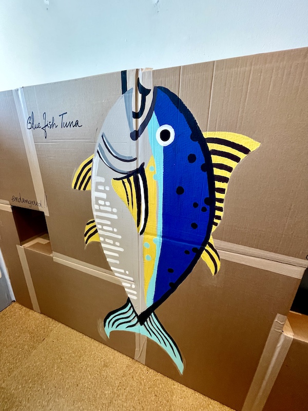 Mural of a blue, turquoise and yellow tuna fish painted on cardboard at Westmoreland Museum of American Art 2