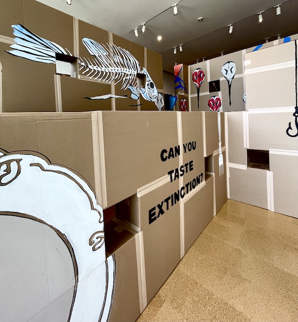 Mural of fish bones and an empty plate painted on cardboard at Westmoreland Museum of American Art 2