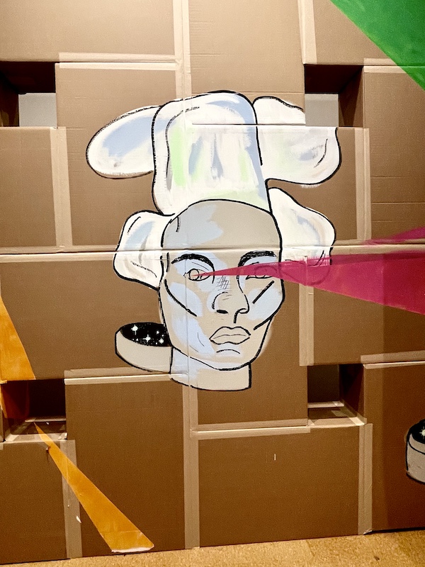 Mural of an Asian man with a white chef hat painted on taped cardboard at Westmoreland Museum of American Art 2