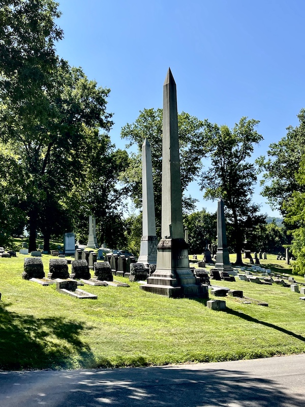 Obelisks and short monuments on the lawn with trees at Allegheny Cemetery Pittsburgh Pennsylvania
