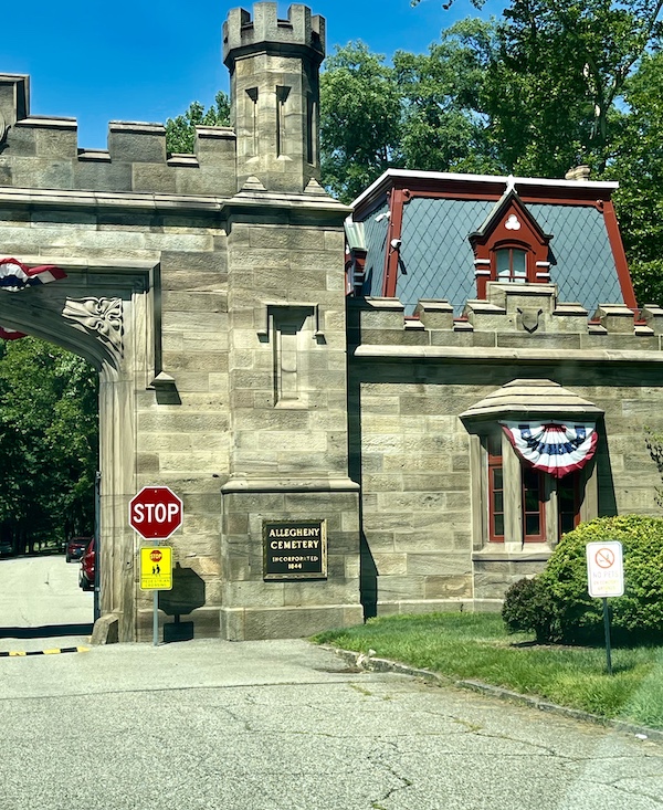 Stone arch and gate house with patriotic decoration at Allegheny Cemetery Pittsburgh Pennsylvania