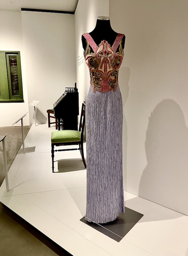 Evening gown with lavender skirt and red, gold and lavender bodice on display at Allentown Art Museum