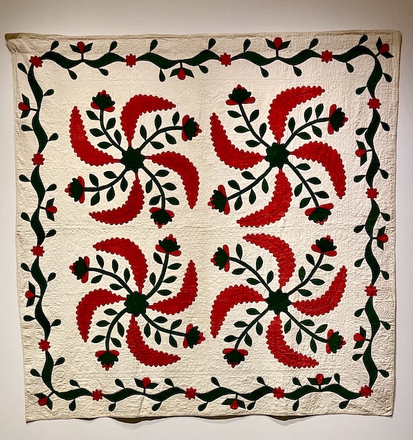 Ivory, red and green quilt of pinwheels and flowers at Allentown Art Museum Quilts