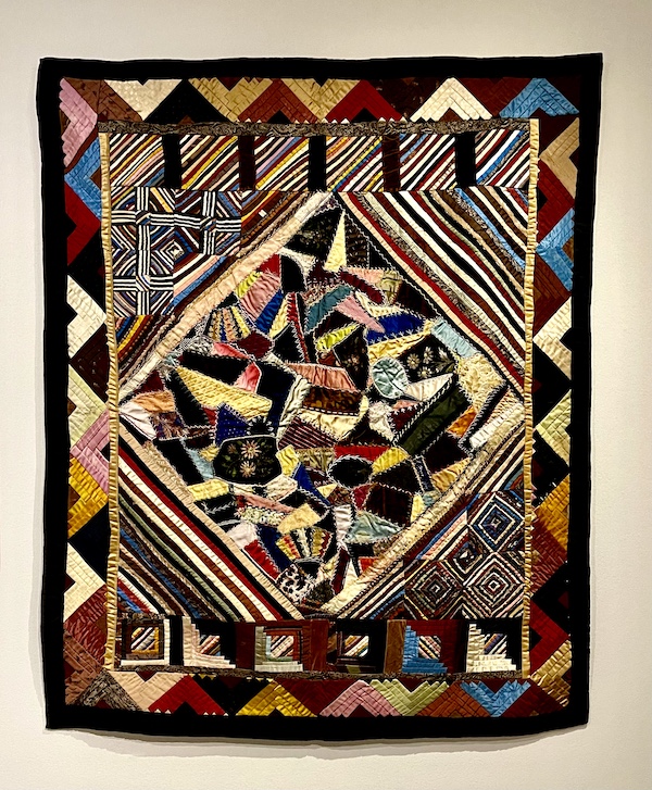 Multicolored patchwork quilt with black border at Allentown Art Museum Quilts
