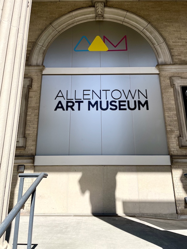 Front entry of the Allentown Art Museum with sign under arch.