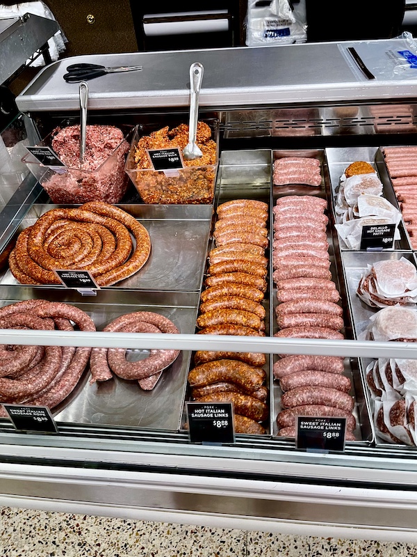 DeLallo Italian Marketplace refrigerator case filled with sausage links, rings and bulk meat