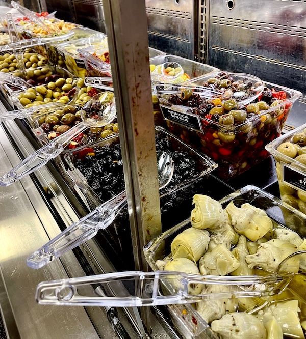 DeLallo Italian Marketplace olive bar with bins including marinated artichokes