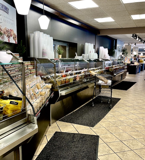 DeLallo Italian Marketplace view if the cheeses and very long olive bar