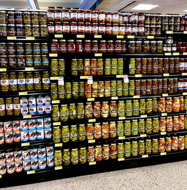 DeLallo Italian Marketplace aisle with shelves full of jars of pickles, olives and peppers