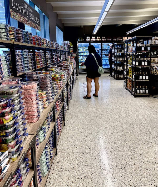 DeLallo Italian Marketplace aisle lined with shelves of containers of candies and snacks