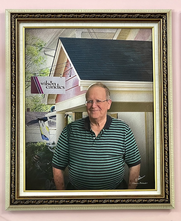 Portrait of Doug Wilson in wood frame at Wilson's Candy shop in Jeannette Pa