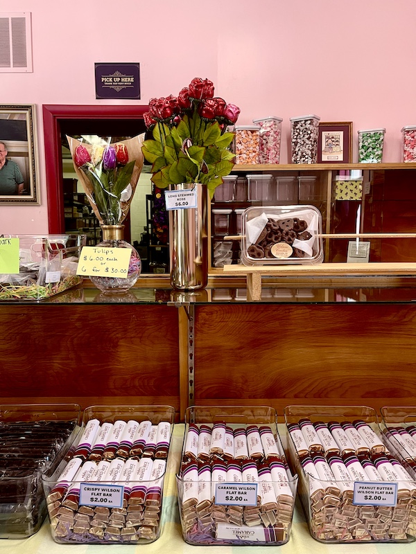 Wood cases and shelves of candies on display at Wilson Candies Jeannette PA