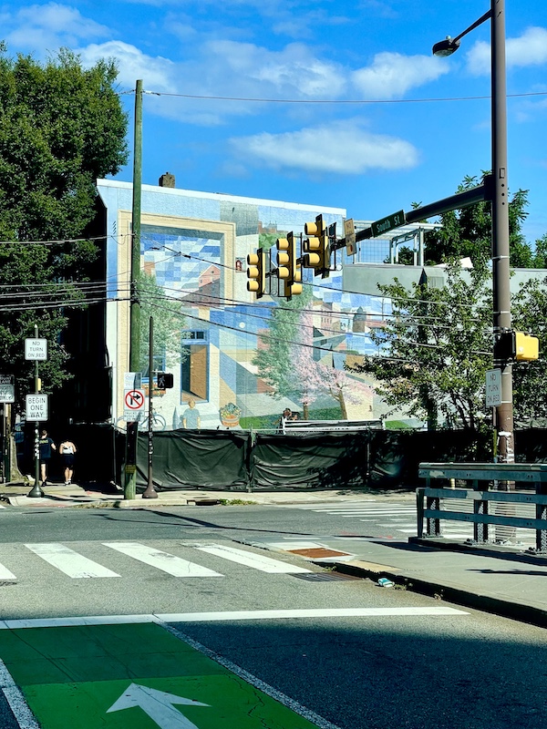 Pastel buildings and open doorways painted mural on a building in Philadelphia