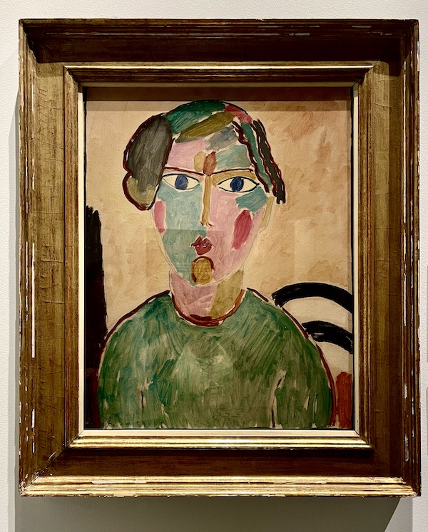 Modern art portrait of a woman with deep blue eyes, green dress and colorful face at the WW2 Museum Degenerative Art exhibit