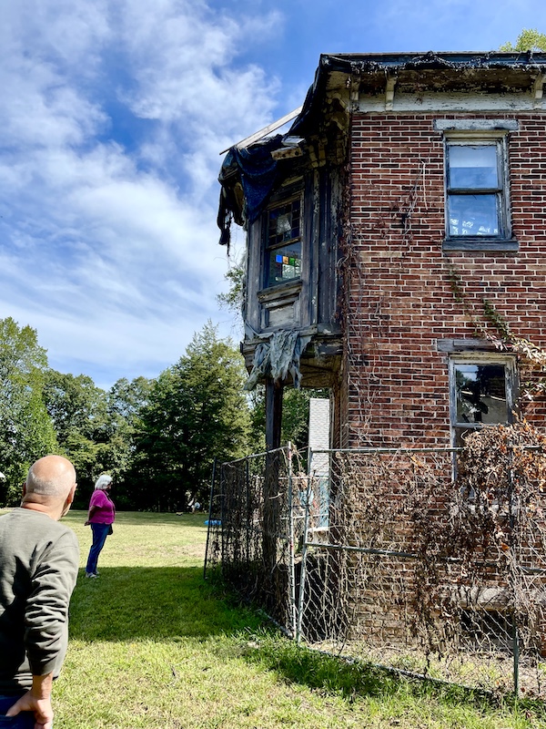 Dilapidated red brick house showing how years and weather have deteriorated it at Alliance Colony Pittsgrove NJ
