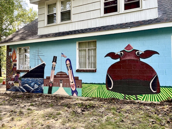 Mural on a house of animals and people, a ship and farmland as part of the story of the creation of Alliance Colony Pittsgrove NJ