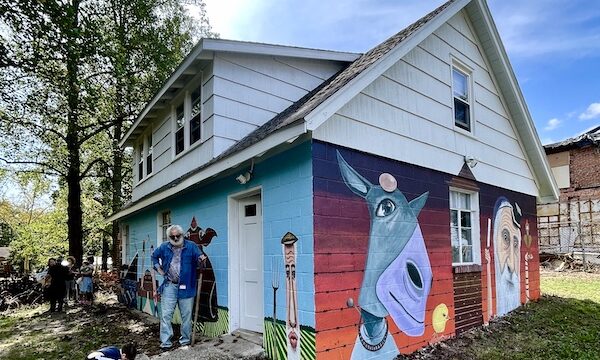 Two walls of a house painted with a mural of animals and people of Alliance Colony Pittsgrove NJ