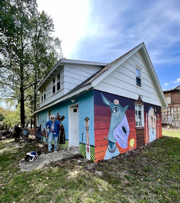 Two walls of a house painted with a mural of animals and people of Alliance Colony Pittsgrove NJ
