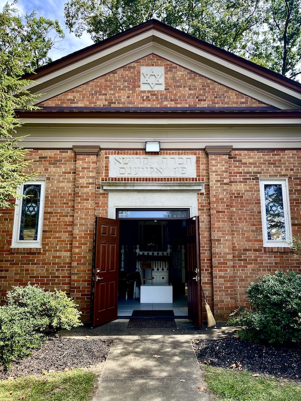 Red brick building with small stained glass windows is the first synagogue at Alliance Colony Pittsgrove NJ