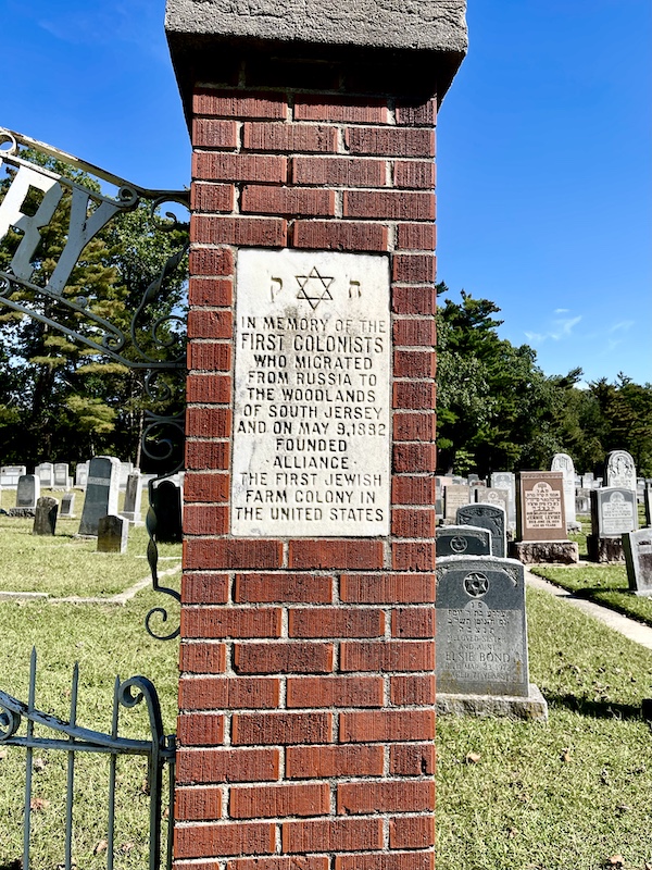 Red brick pillar with white faceplate commemorating the original colonists who lived and farmed there. This was at the entrance to the Alliance Cemetery